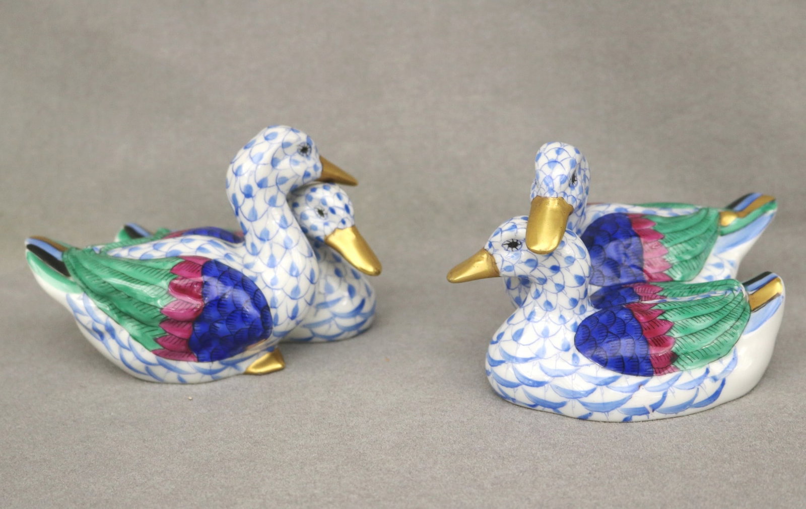 TWO HEREND POLYCHROMED PORCELAIN FIGURES OF PAIRS OF DUCKS, - L: 4 1/4 in.: TWO HEREND POLYCHROMED PORCELAIN FIGURES OF PAIRS OF DUCKS. Both with some blue fishscale grounds - L: 4 1/4 in.
