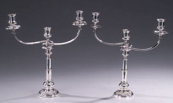 TWO SILVER PLATED THREE-LIGHT CANDELABRA,: TWO SILVER PLATED THREE-LIGHT CANDELABRA, 19th century. The three-light branching arms by Matthew Boulton, Sheffield, circa 1820, with urn shaped sockets and reeded, scrolling arms, on later bases, th