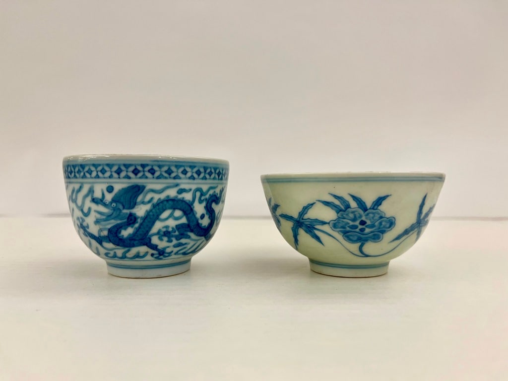 TWO CHINESE BLUE AND WHITE PORCELAIN RING-FOOTED BOWLS,: TWO CHINESE BLUE AND WHITE PORCELAIN RING-FOOTED BOWLS. One, decorated with trailing, flowering vine, D: 3 3/8"; other, with five-toed dragons, D: 3". Each has six-character mark under foot.
