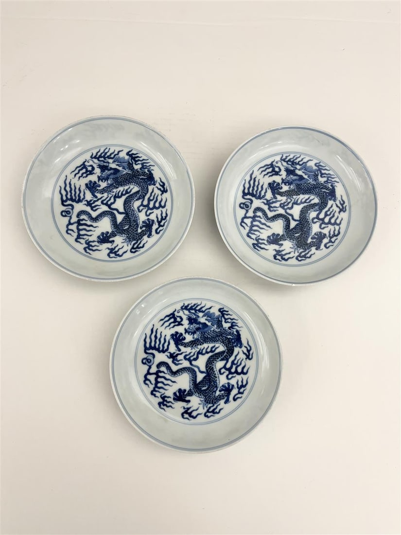 THREE CHINESE BLUE AND WHITE PORCELAIN PLATES, - D: 6 3/4 in.: THREE CHINESE BLUE AND WHITE PORCELAIN PLATES. Withing five-toed dragon decoration; six-character mark under foot - D: 6 3/4 in.