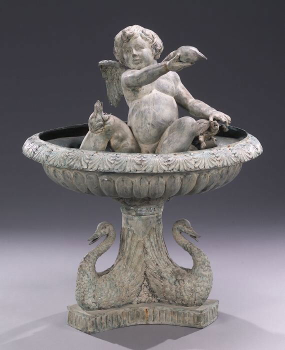 A PATINATED BRONZE FOUNTAIN. Cast with a: A PATINATED BRONZE FOUNTAIN. Cast with a putto holding a shell and with a turtle and frog within a circular basin with anthemion rim on a swan-form shaped base. - 49 in. x 38 in.
