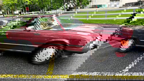 1989 MERCEDES-BENZ 560SL TWO-DOOR RUBY RED METALLIC ROADSTER CONVERTIBLE AUTOMOBILE. - Mileage: