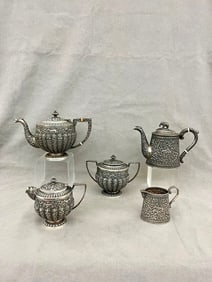 THREE-PIECE HAND-CRAFTED INDIAN SILVER TEA SERVICE WITH CLOSELY SIMILAR TWO-PIECE COFFEE SET, -