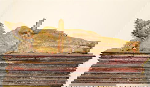 THAI GILT-WOOD FIGURE OF RECLINING BUDDHA ON PLINTH BASE. - length: 36 inches; height: 17 inches