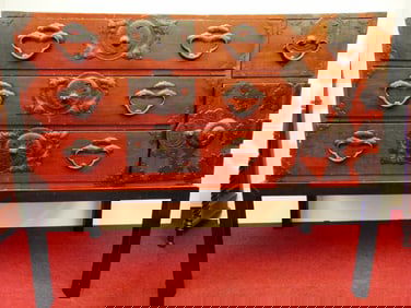 JAPANESE RED TANSU LACQUERED ON SEPARATE BLACK LACQUERED STAND. - H: 45"; W: 48"; D: 24 1/2".
