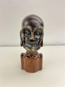 JAPANESE CAST BRONZE BUST OF MAN. Separate carved wooden base.