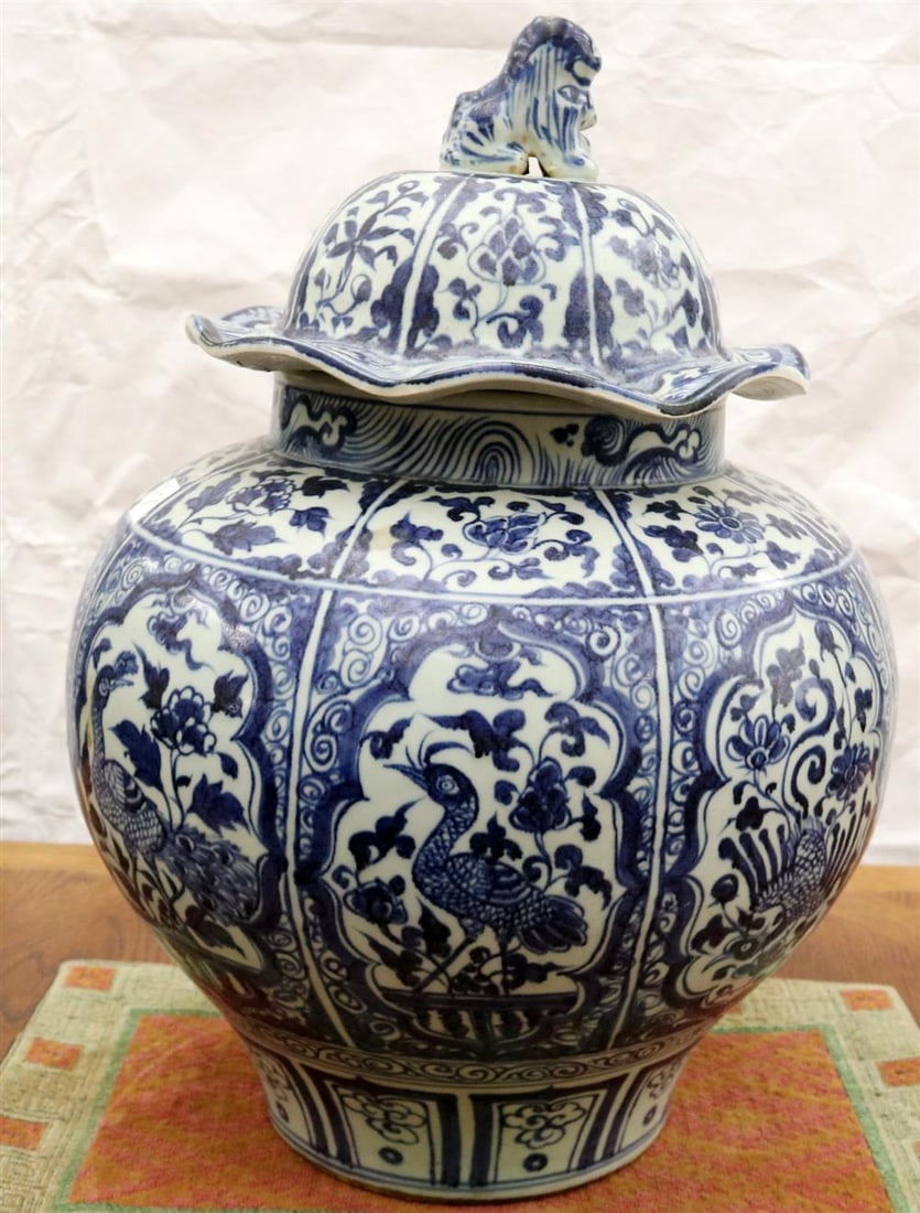 CHINESE BLUE AND WHITE PORCELAIN LIFT-COVER JAR, - H' 21 in.: CHINESE BLUE AND WHITE PORCELAIN LIFT-COVER JAR. Panels of floral decoration, swimming ducks, and other motifs. Cover has undulating border and fu dog finial. - H' 21 in.