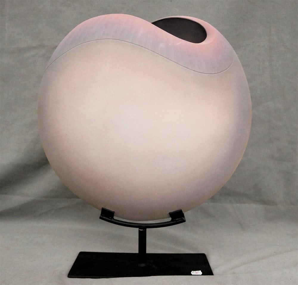 CAROLYN SALE, American contemporary.: CAROLYN SALE, American contemporary. Ceramic stylized moon flask vessel in pale shaded pink and blue; mounted on metal stand. H: 20". With stand.