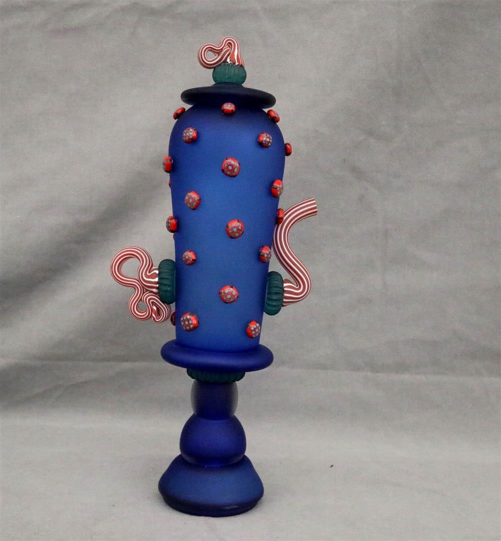 AMERICAN CONTEMPORARY GLASS ARTISAN / BLUE ART GLASS. whimsical pedestal-base teapot with: AMERICAN CONTEMPORARY GLASS ARTISAN / BLUE ART GLASS. whimsical pedestal-base teapot with candystripe handle, spout, and lid finial. Signed. H: 16 ½". .