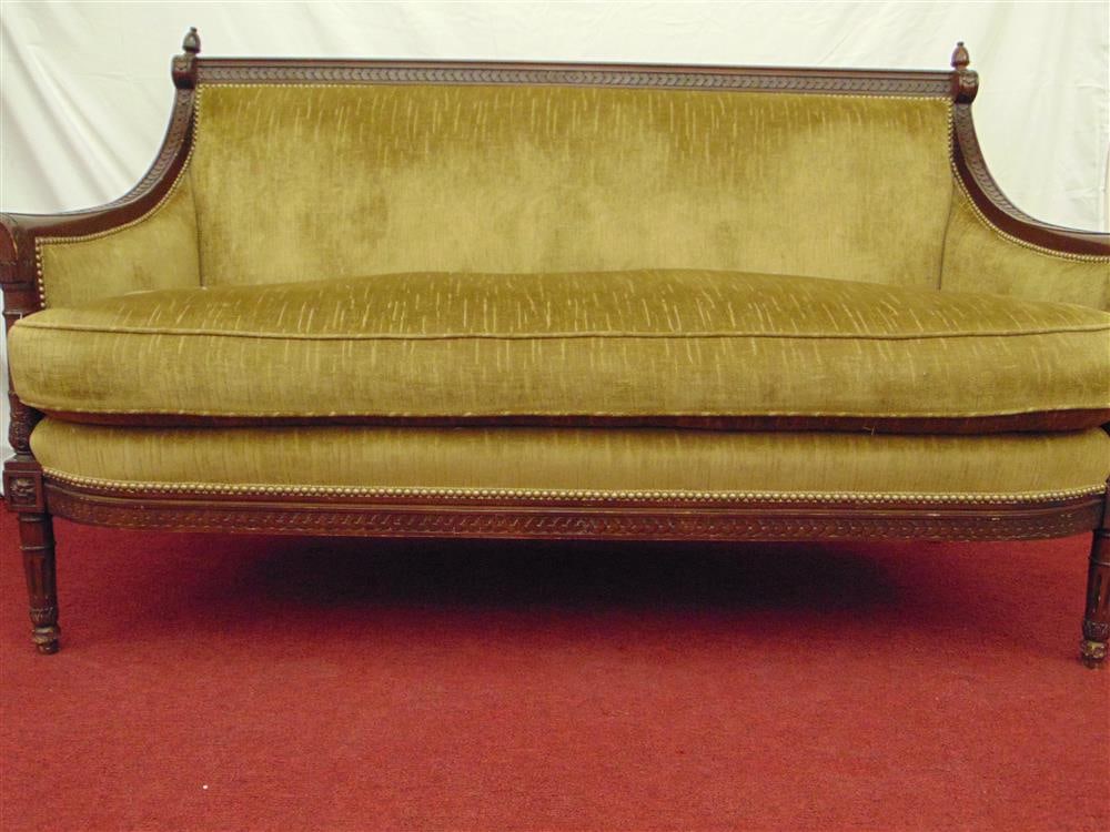 LOUIS XVI-STYLE CARVED MAHOGANY SETTEE WITH OLIVE GREEN PLUSH UPHOLSTERY, - W: 66 in.: LOUIS XVI-STYLE CARVED MAHOGANY SETTEE WITH OLIVE GREEN PLUSH UPHOLSTERY. Carved frame and tapering circular legs; brass nailhead trim - W: 66 in.