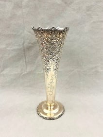 LATE 19TH CENTURY STERLING SILVER TRUMPET VASE WITH FLORAL REPOUSSE BORDER,