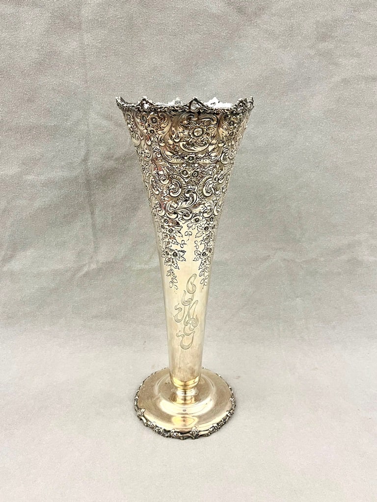 LATE 19TH CENTURY STERLING SILVER TRUMPET VASE WITH FLORAL REPOUSSE BORDER,: LATE 19TH CENTURY STERLING SILVER TRUMPET VASE WITH FLORAL REPOUSSE BORDER. Retailed by Harris & Shafer, Washington, D.C. H: 14 1/2". WT: 27 troy oz.Property of Visionary Architect Arthur Cotton Moore