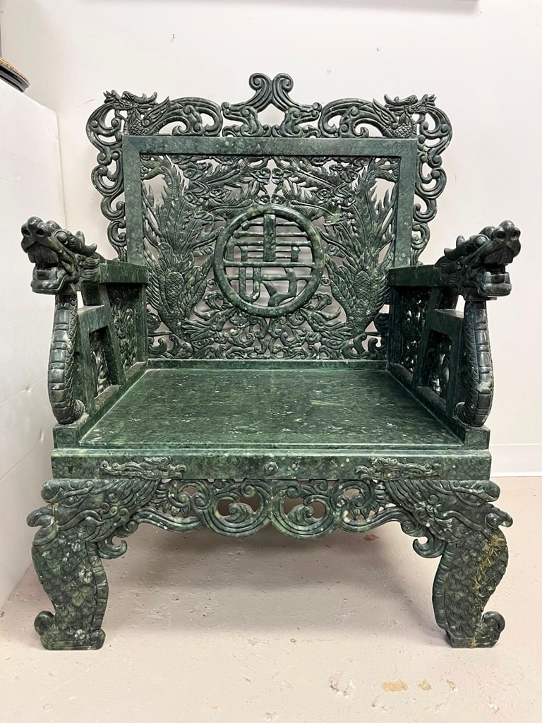 CHINESE CARVED MOTTLED GREEN HARDSTONE OPEN-ARM EMPRESS CHAIR. - H: 45".: CHINESE CARVED MOTTLED GREEN HARDSTONE OPEN-ARM EMPRESS CHAIR. Overall carved with foliage centering Chinese character medallion; dragon hand holds. - H: 45".