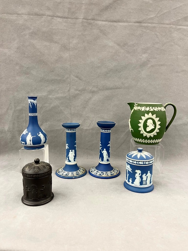 SIX ITEMS WEDGWOOD JASPERWARE PORCELAIN.: SIX ITEMS WEDGWOOD JASPERWARE PORCELAIN. Including pair Queensware candlesticks, H: 6 3/4 in. ; bottle vase; lift-cover cylindrical jar; black basalt lift-cover jar, and ovoid portrait pitcher with g