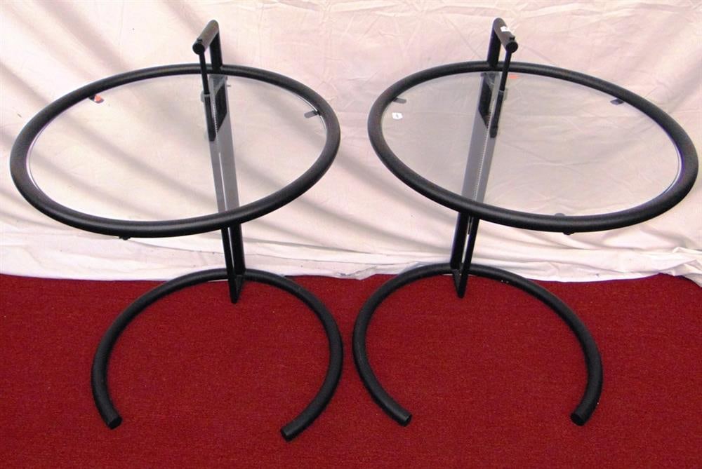 PAIR OF EILEEN GRAY STYLE BLACK-PAINTED METAL AND GLASS OCCASIONAL TABLES. - H: 22 in.; top, D: 20: PAIR OF EILEEN GRAY STYLE BLACK-PAINTED METAL AND GLASS OCCASIONAL TABLES. Arm design Ltd., recent issue of circular form. - H: 22 in.; top, D: 20 in.Property of Visionary Architect Arthur Cotton Moo