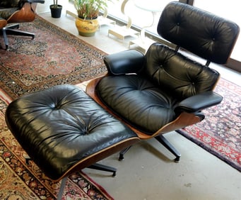CHARLES AND RAY EAMES ROSEWOOD AND BLACK LEATHER UPHOLSTERED 670 LOUNGE CHAIR AND 671 OTTOMAN,