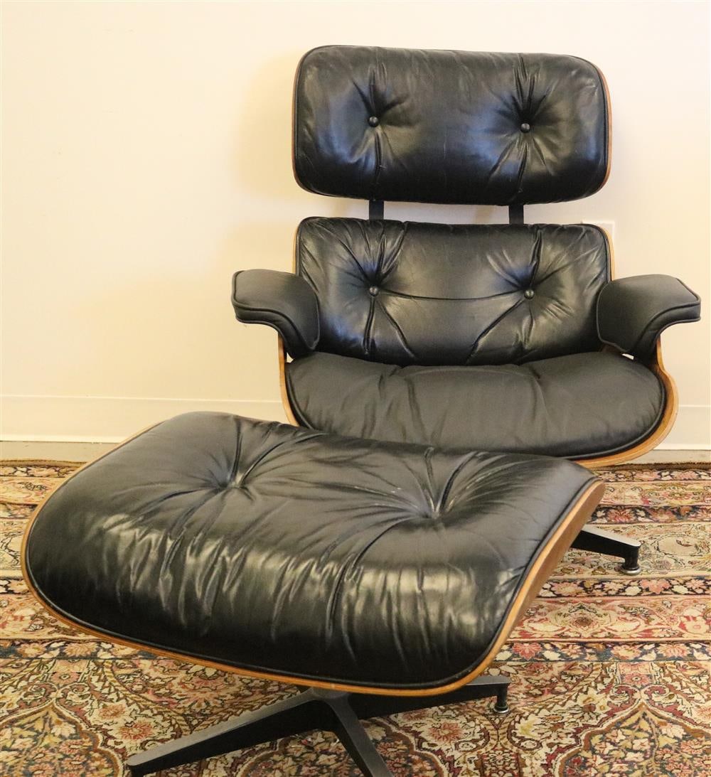 CHARLES AND RAY EAMES ROSEWOOD AND BLACK LEATHER UPHOLSTERED 670 LOUNGE CHAIR AND 671 OTTOMAN,: CHARLES AND RAY EAMES ROSEWOOD AND BLACK LEATHER UPHOLSTERED 670 LOUNGE CHAIR AND 671 OTTOMAN. Upholstery exhibits wear and chips to rosewood veneer.Property of Visionary Architect Arthur Cotton Moore