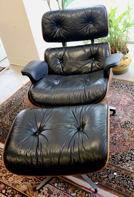 CHARLES AND RAY EAMES ROSEWOOD AND BLACK LEATHER UPHOLSTERED 670 LOUNGE CHAIR AND 671 OTTOMAN.: CHARLES AND RAY EAMES ROSEWOOD AND BLACK LEATHER UPHOLSTERED 670 LOUNGE CHAIR AND 671 OTTOMAN. Upholstery exhibits wear and chips to rosewood veneer.Property of Visionary Architect Arthur Cotton Moore