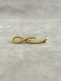 SIGNED ANGELA CUMMINGS 18K YELLOW GOLD AND DIAMOND LOOPED ROPE DESIGN PIN. 1985.