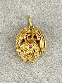 ITALIAN 18K YELLOW GOLD DOG HEAD PENDANT WITH ROUND RUBY NOSE.