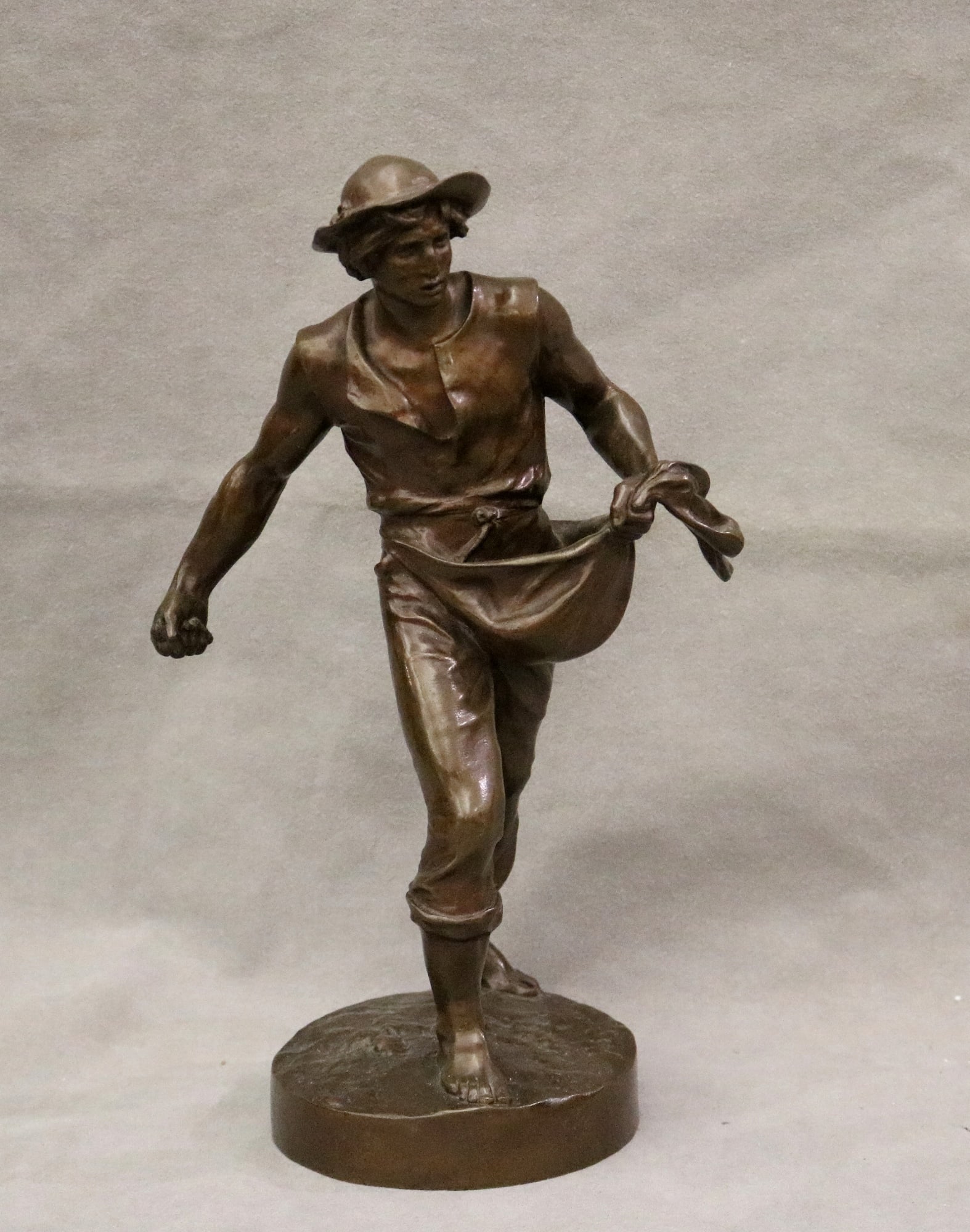 AFTER JEAN GAUTHERIN (French, 1840 - 1890). The Sower, Patinated bronze figure. Signed at base.: AFTER JEAN GAUTHERIN (French, 1840 - 1890). The Sower, Patinated bronze figure. Signed at base. - Height: 13.25 inches