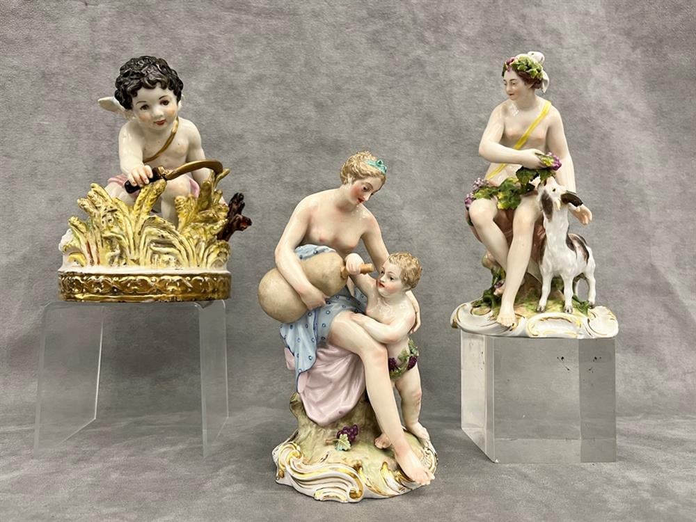 THREE GERMAN POLYCHROME PORCELAIN FIGURES. 19th century. - Tallest, H; 8 in.: THREE GERMAN POLYCHROME PORCELAIN FIGURES. 19th century. One, after Meissen, modeled as cherub with scythe cutting wheat, H: 6 1/2 in.; two Royal Berlin of Neoclassical female nudes, one with grapes a