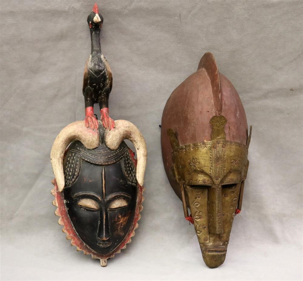 TWO PATINATED AFRICAN DECORATED WOODEN MASKS, Late 20th century. - height (Baule Mask): 20 inches.: TWO PATINATED AFRICAN DECORATED WOODEN MASKS, Late 20th century. Mask (pictured on the left) is a Baule mask from Ivory Coast. The mask on the right is a brass covered Marka mask from Mali. - height (