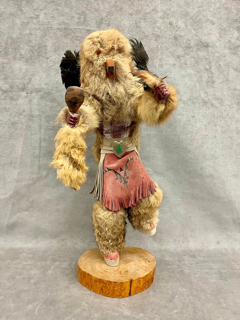 NATIVE AMERICAN KACHINA DOLL. - H: 18 1/2 in.: NATIVE AMERICAN KACHINA DOLL. Carved and painted as ceremonial dancee with furskins; signed illegibly on wooden plinth base. - H: 18 1/2 in.