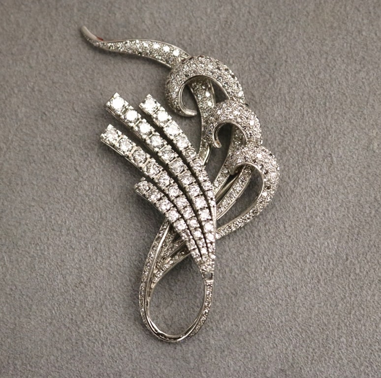 PLATINUM AND DIAMOND SCROLL AND SPRAY DESIGN PIN.: PLATINUM AND DIAMOND SCROLL AND SPRAY DESIGN PIN. Approximately 250 graduated round diamonds together weighing approximately 8.00 ct. L: 3". Gross wt: 12 dwt.