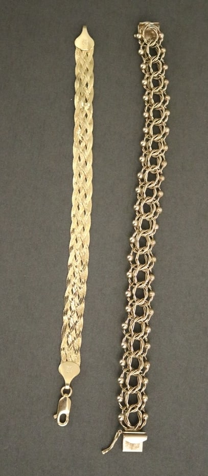 TWO 14K YELLOW GOLD FLEXIBLE LINK BRACELETS, - Wt. 19 dwt.: TWO 14K YELLOW GOLD FLEXIBLE LINK BRACELETS. Once, constructed of openwork double-round wire design links, L: 7 1/2 in. Other, a braided strap, L: 7 1/4 in., including clasp - Wt. 19 dwt.