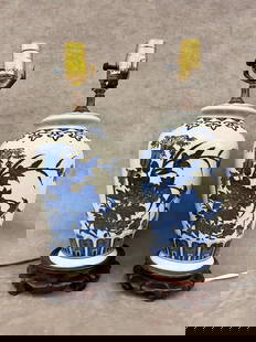 PAIR CHINESE PROVINCIAL BLUE AND WHITE PORCELAIN VASES MOUNTED AS TABLE LAMPS, 19th century. - Vase: PAIR CHINESE PROVINCIAL BLUE AND WHITE PORCELAIN VASES MOUNTED AS TABLE LAMPS, 19th century. Figural and trailing vine decoration; teakwood stands - Vase portion, H: 11 3/4 in.