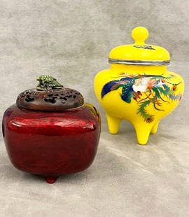 TWO JAPANESE CENSERS,: TWO JAPANESE CENSERS. One, wireless cloisonne footed, lift-top pot with mythical bird decoration on yellow ground, H: 5 3/4 in.; other, cushion-shape vessel with red guilloche-type enamel ground havi