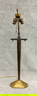 ART DECO BRONZE DESIGNER TWO-LIGHT TABLE LAMP,: ART DECO BRONZE DESIGNER TWO-LIGHT TABLE LAMP. Paneled, domed rectangular base; flaring, paneled support. H: 30", to top of finial.