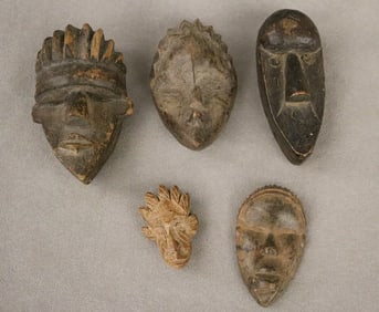 LIBERIAN AND IVORY COLLECTION OF PASSPORT MASKS, - Average height: 3 inches.