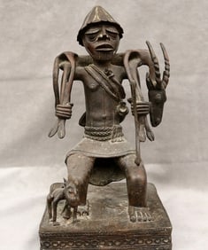NIGERIAN LOWER NIGER SCULPTURE OF A SEATED HUNTER AND DOG, - Height: 14 inches.