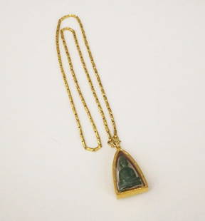 INDIAN 22K-23K YELLOW GOLD FLEXIBLE-LINK CHAIN SUSPENDING GOLD-MOUNTED CRYSTAL TRIANGULAR SHADOW BOX: INDIAN 22K-23K YELLOW GOLD FLEXIBLE-LINK CHAIN SUSPENDING GOLD-MOUNTED CRYSTAL TRIANGULAR SHADOW BOX PENDANT ENCLOSING CARVED GREEN JADE FIGURE OF BUDDHA. - Chain. L: 22 in. Wt.: 8 dwt. Pendant, L: 2