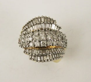 14K YELLOW AND WHITE GOLD AND DIAMOND SWIRLED RING, - Ring size: 6 1/2. Gross wt. 8 dwt.