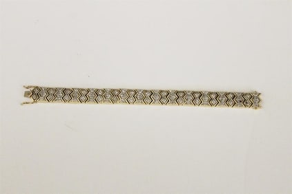 14K YELLOW GOLD AND DIAMOND STRAP BRACELET. - L: 7 1/2 in. W: 1/2 in. Gross wt. 1 oz. 8 dwt.
