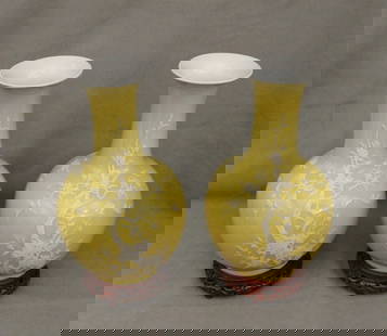 PAIR CHINESE PORCELAIN YELLOW GROUND, BOTTLE-FORM VASES, - H: 13 in.: PAIR CHINESE PORCELAIN YELLOW GROUND, BOTTLE-FORM VASES.  White pate-sur-pate type flowering branch decoration. Carved teakwood stands. - H: 13 in.