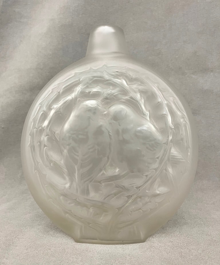 SIGNED R. LALIQUE FROSTED COLORLESS CRYSTAL MOON FLASK WITH RELIEF LOVE-BIRD MOTIF, - H: 8 in.: SIGNED R. LALIQUE FROSTED COLORLESS CRYSTAL MOON FLASK WITH RELIEF LOVE-BIRD MOTIF. Etched signature. - H: 8 in.