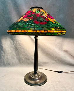 TIFFANY STYLE ART GLASS THREE-LIGHT TABLE LAMP. - H: 22 1/2 in. Shade, D: 16 in.: TIFFANY STYLE ART GLASS THREE-LIGHT TABLE LAMP.  Flaring conical shade with leaded channels and various color slag glass floral tiles; hexagonally paneled bronze base stamped "Tiffany Studios/New York