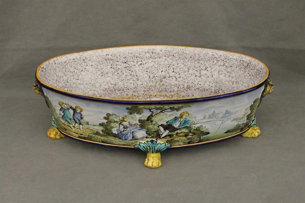 ITALIAN ENAMELED OVAL BASIN. - L: 22 in.: ITALIAN ENAMELED OVAL BASIN. Painted with scenes of 18th century figures in bucolic landscapes; lion mask handles; lion paw feet. Repaired - L: 22 in.