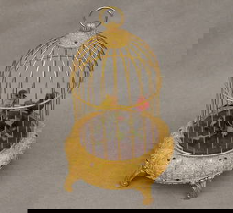 VINTAGE GILT BIRD CAGE AUTOMATON MUSIC BOX. - Height: 10 1/4 inches.: VINTAGE GILT BIRD CAGE AUTOMATON MUSIC BOX. One red and one yellow tweeting bird. - Height: 10 1/4 inches.
