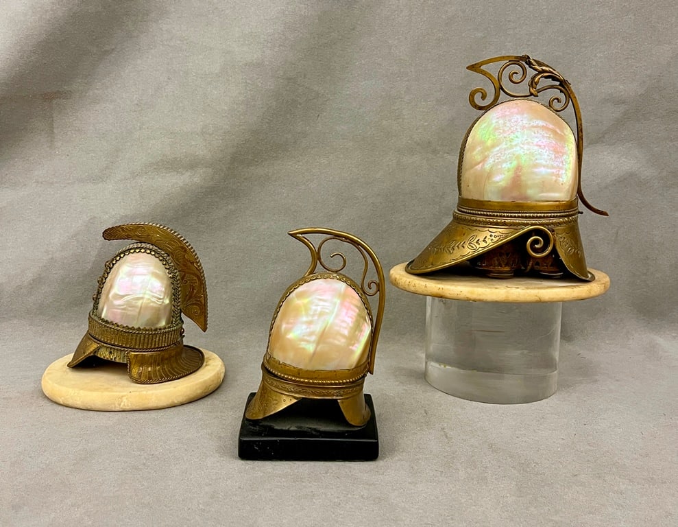 THREE ASSORTED VICTORIAN BRASS-MOUNTED ABALONE SHELL/MOTHER-OF-PEARL MODELS OF HELMETS, - Largest,: THREE ASSORTED VICTORIAN BRASS-MOUNTED ABALONE SHELL/MOTHER-OF-PEARL MODELS OF HELMETS. On plinth base. - Largest, H: 7 1/4 in.