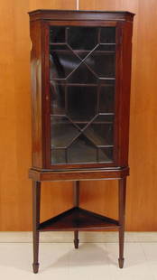 GEORGE III MAHOGANY SMALL CORNER CUPBOARD ON STAND. - H: 70 3/8 in.; W: 29 in.; D: 16 1/2 in.: GEORGE III MAHOGANY SMALL CORNER CUPBOARD ON STAND.  Flat molded cornice over glazed door divided by mullions into thirteen geometric panes; stand has tapering square legs ending in spade feet joined