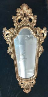 19TH CENTURY CONTINENTAL CARVED AND GOLD LEAFED CARTOUCHE SHAPE WALL MIRROR WITH SCROLL AND SHELL: 19TH CENTURY CONTINENTAL CARVED AND GOLD LEAFED CARTOUCHE SHAPE WALL MIRROR WITH SCROLL AND SHELL CREST. - H: 33".