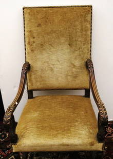 TWO CONTINENTAL CARVED OAK OPEN-ARM, HIGH BACK UPHOLSTERED CHAIRS. 18th-19th century.: TWO CONTINENTAL CARVED OAK OPEN-ARM, HIGH BACK UPHOLSTERED CHAIRS. 18th-19th century. Gold plush fabric with brass nail-head trim. One with carved arms having leaf handholds