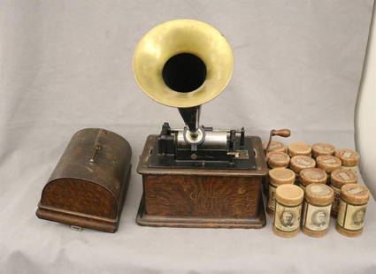 EARLY EDISON TABLE-TOP CYLINDER PHONOGRAPH WITH METAL HORN AND 14 WAX CYLINDERS, - H: 11 1/2 in.,: EARLY EDISON TABLE-TOP CYLINDER PHONOGRAPH WITH METAL HORN AND 14 WAX CYLINDERS.  Oak case. - H: 11 1/2 in., excluding horn.