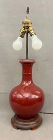 CHINESE SANG-DE-BOEUF GLAZED PORCELAIN BOTTLE VASE MOUNTED AS TWO-LIGHT TABLE LAMP. - Vase portion,