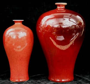 TWO CHINESE OXBLOOD OR SANG-DE-BOEUF GLAZED PORCELAIN MEI PING SHAPED VASES. - Height (tallest